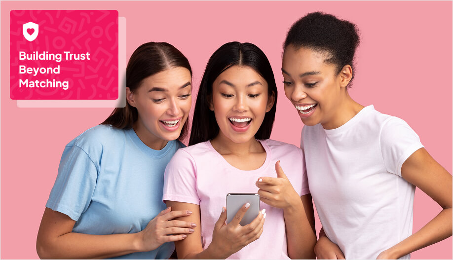 3 women with laughing and excitedly looking at a phone
