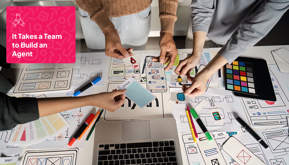 a group of working people brainstorming over the table with paper layouts around